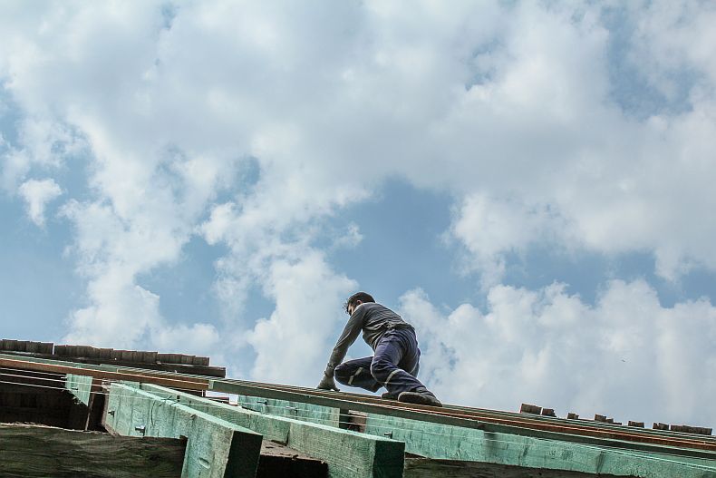 Blue skies and a man on roof