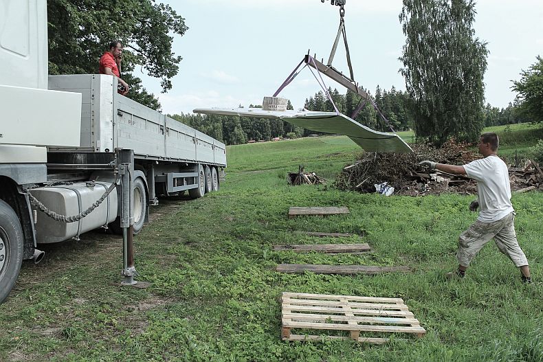 Unloading metal roof from the cargo truck