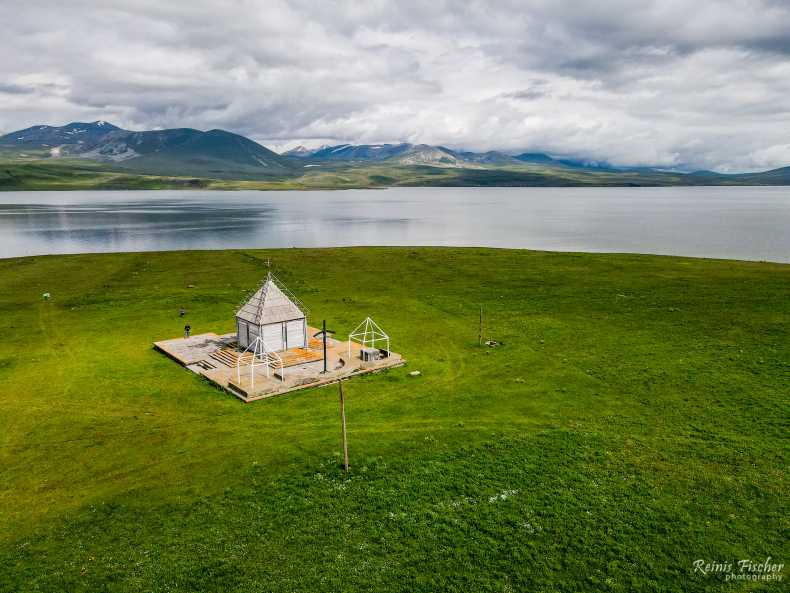 Little wooden church in front of Paravani lake in Georgia