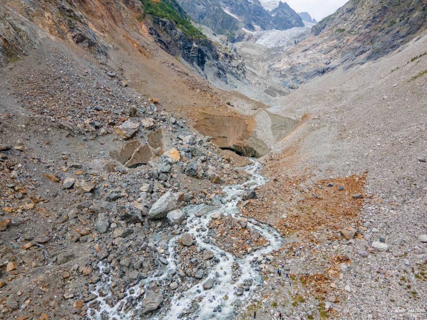Aerial view of a glacial stream flowing through the rocky Chalaadi valley near Mestia