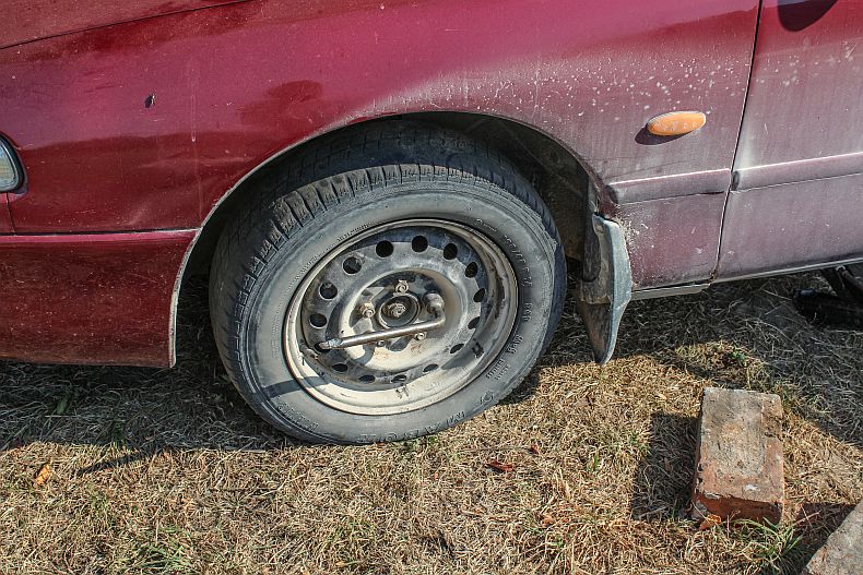 Use the wrench to loosen the lug nuts