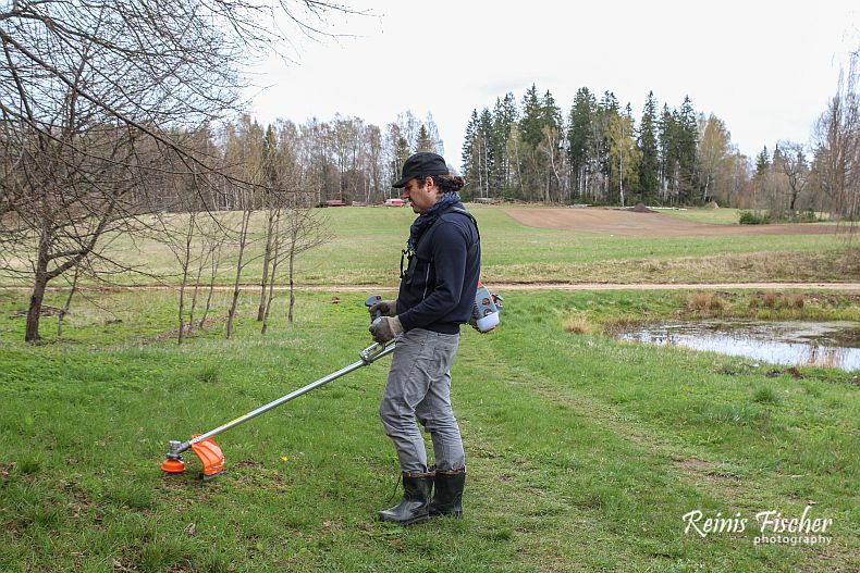 Author of this blog captured in action - trimming grass