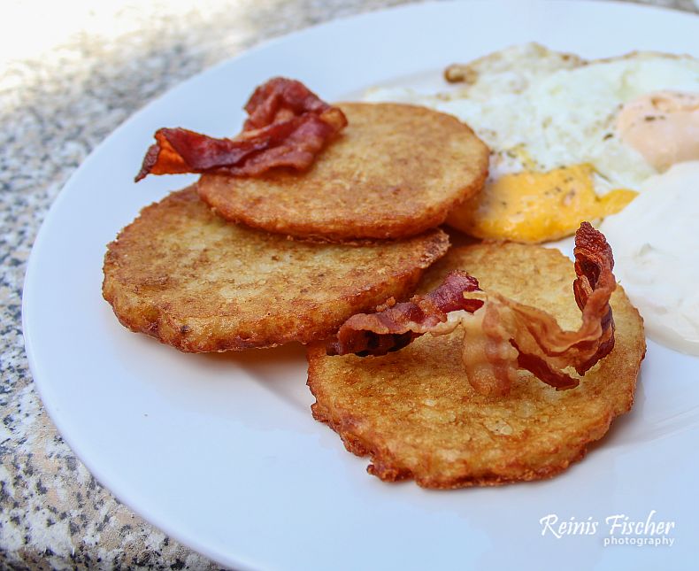 Potato pancakes with sliced bacon