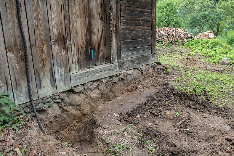 Trench around old foundation and electricity cable