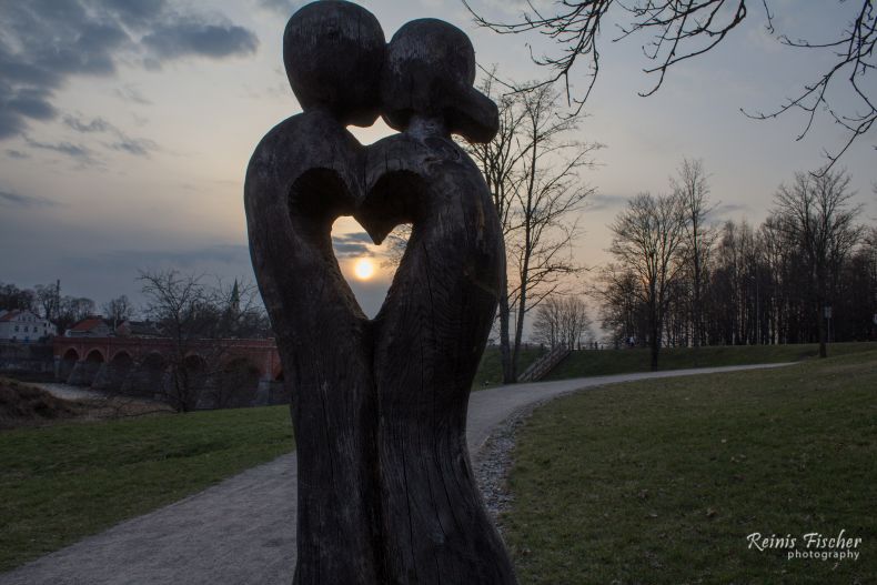Statue of Love during sunset in Kuldīga
