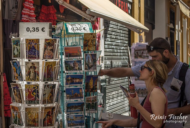 Tourists buying postcards in Seville