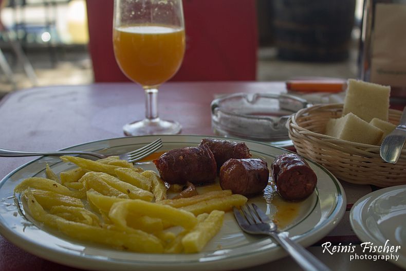 French fries, chorizo and orange juice