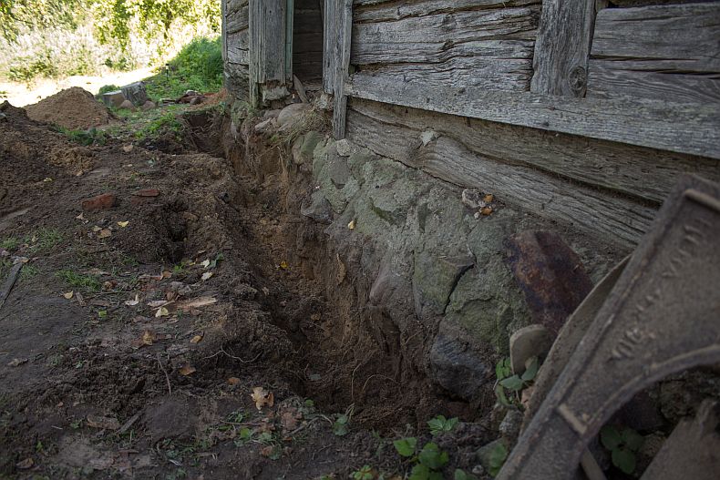 Digging a trench around existing foundation