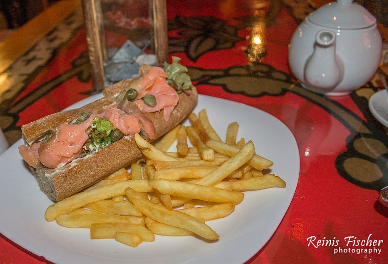 Salmon sandwich served with french fries